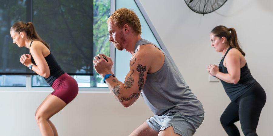 three people participating in a group fitness class