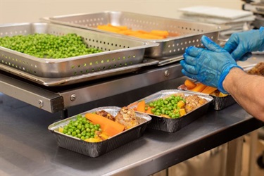 Staff preparing meals to be delivered to seniors.