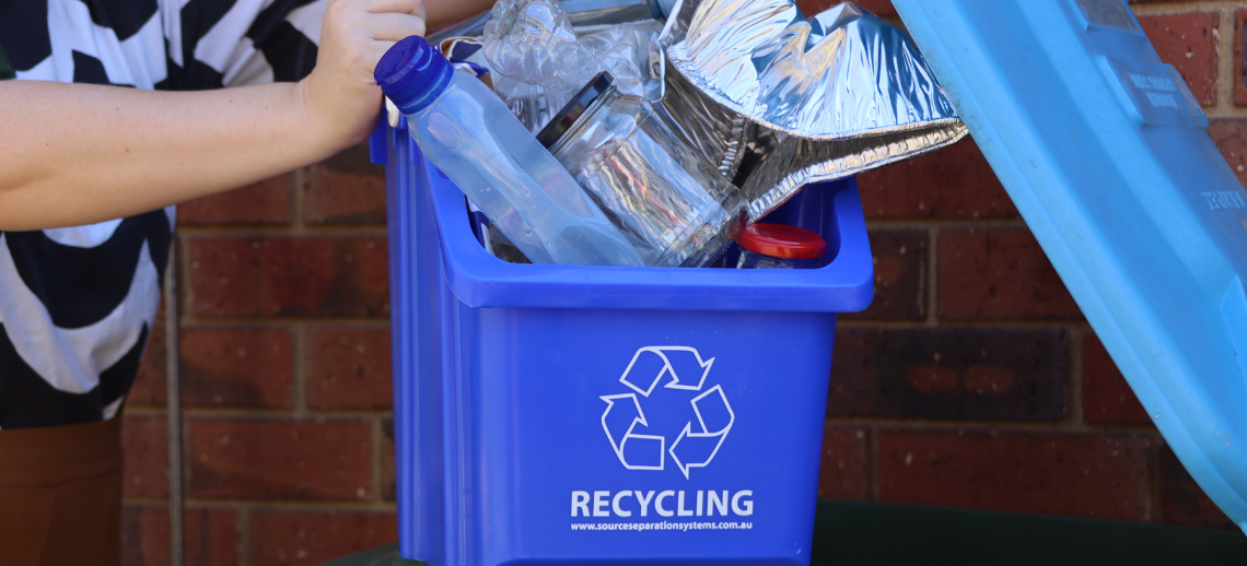 Recyclable materials being put into a recycling bin