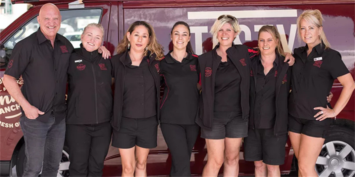 7 people standing in front of a delivery van