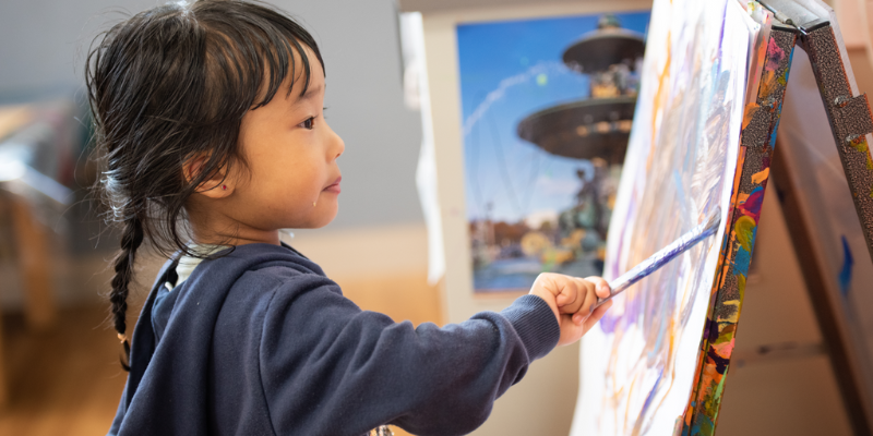 Young child painting CALD child painting