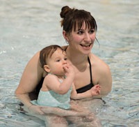 Parent swimming with their child