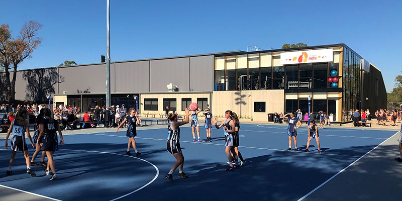 young people playing netball on the outdoor courts at the Maroondah Nets facility