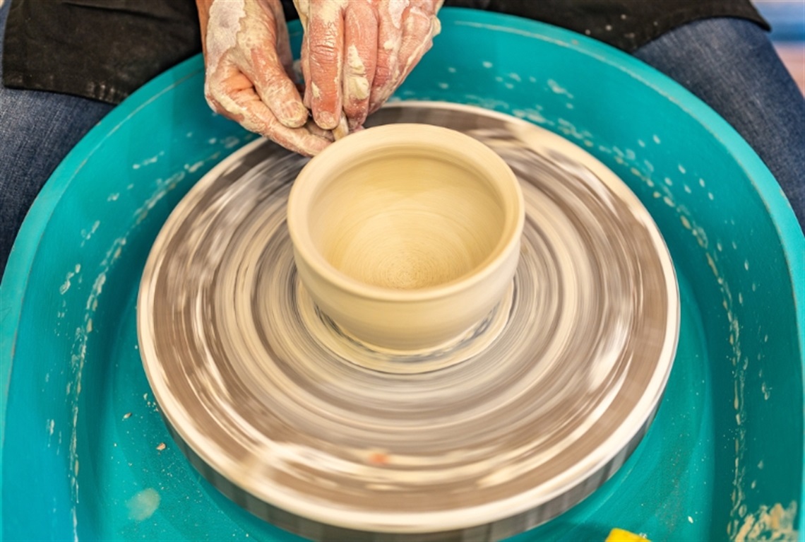 Clay being worked on a pottery wheel