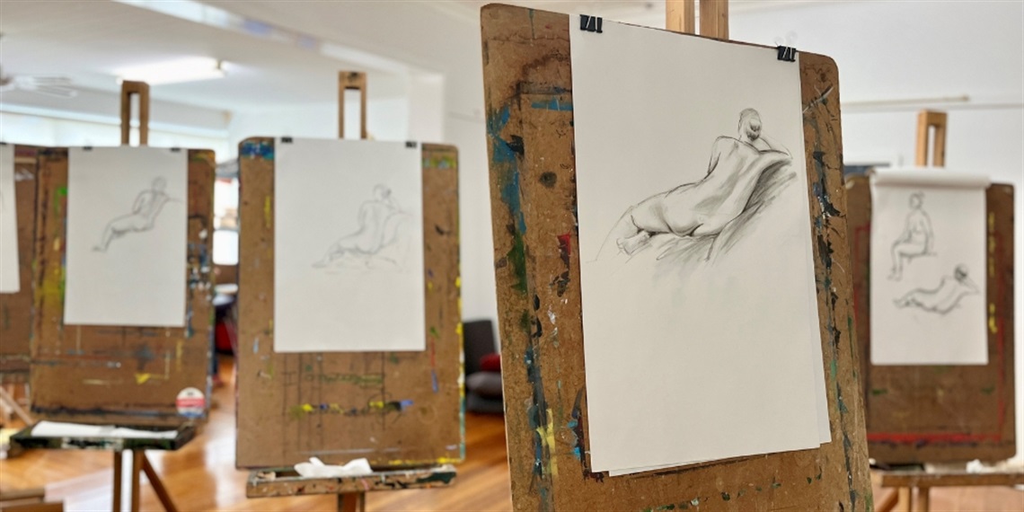 Easels set up with a charcoal drawing replicated across them