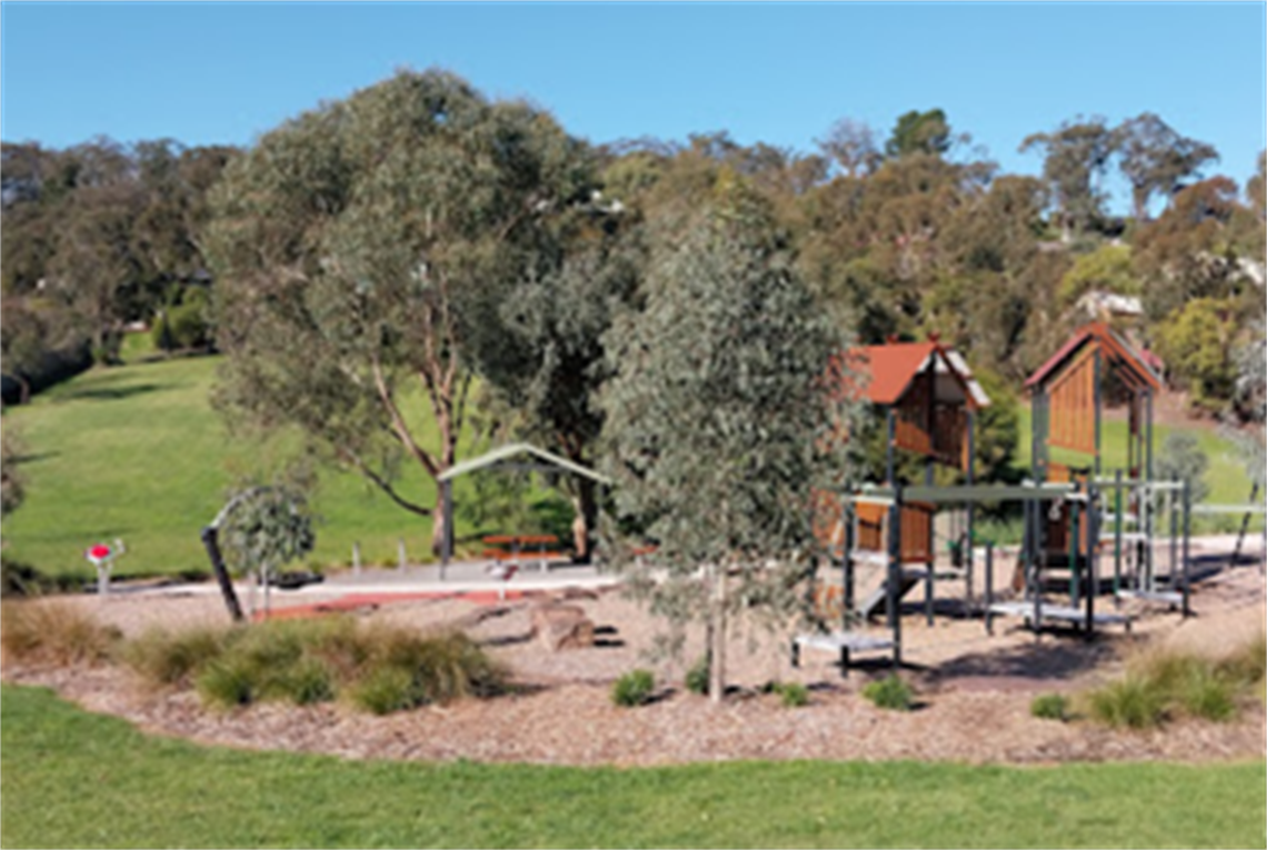 playground at Nangathan Way Reserve, built in natural wood and nature tones and set in a green open space.