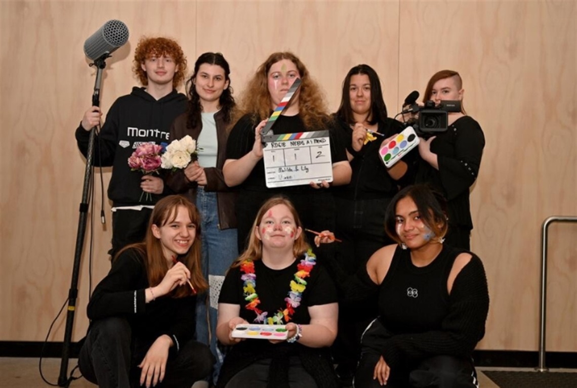 A group of young people holding filming equipment