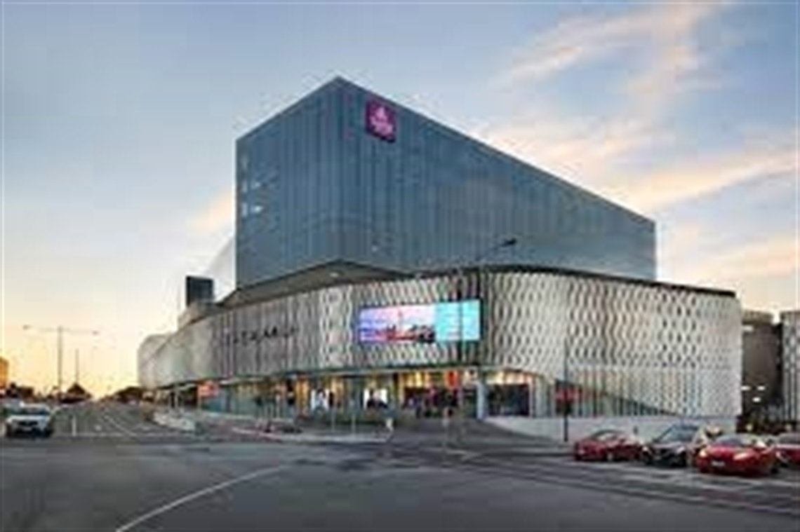 Image of Eastland shopping centre and Sage hotel at dusk, contrasting against a sunset