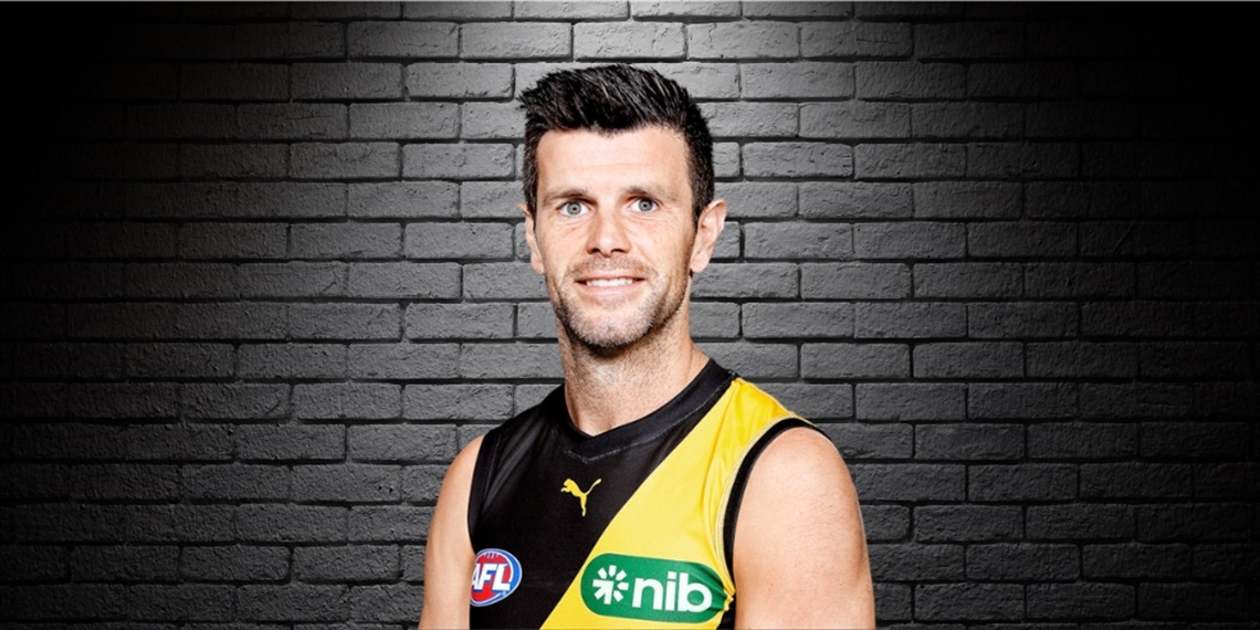 Trent Cotchin standing in front of black brick wall