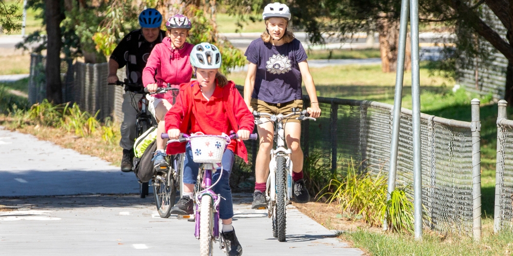 A family riding their bikes along a trail