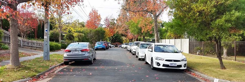 local street with cars parked on side of road