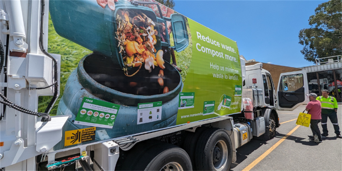 FOGO collection truck with two people looking in the door.png