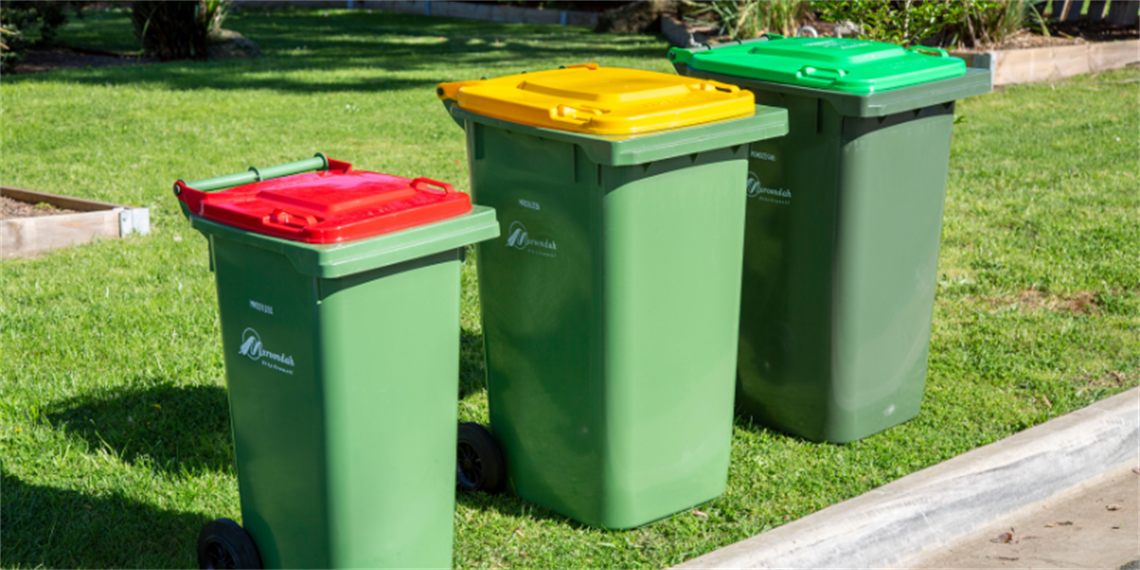 three kerbside bins -red lid, yellow lid and green lid.png