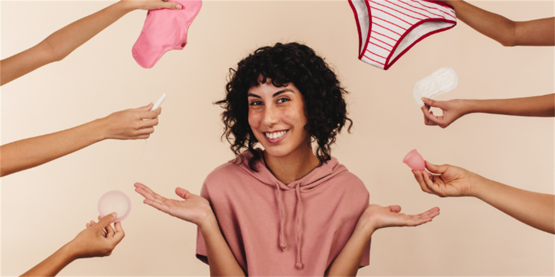 Woman with reusable and single use period products.png