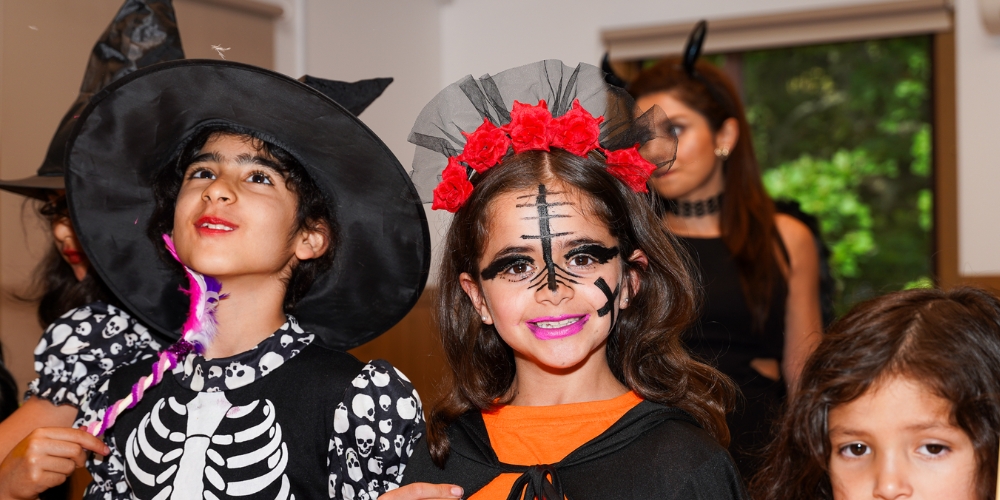 Three children dressed in Halloween costumes